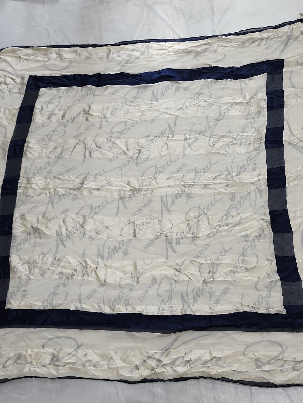 Nina Ricci Silk Scarf Featuring Logo Pattern and Double Navy Blue Border. Cream